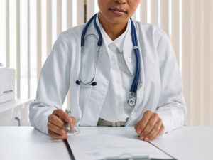 female doctor reviewing patient chart at her desk